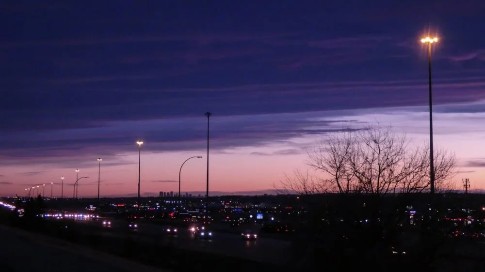 a night time view of a parking lot and street lights