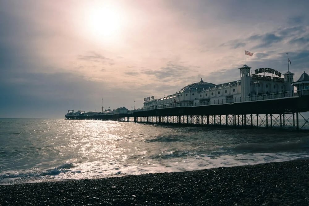 a pier on a beach with a sky background
