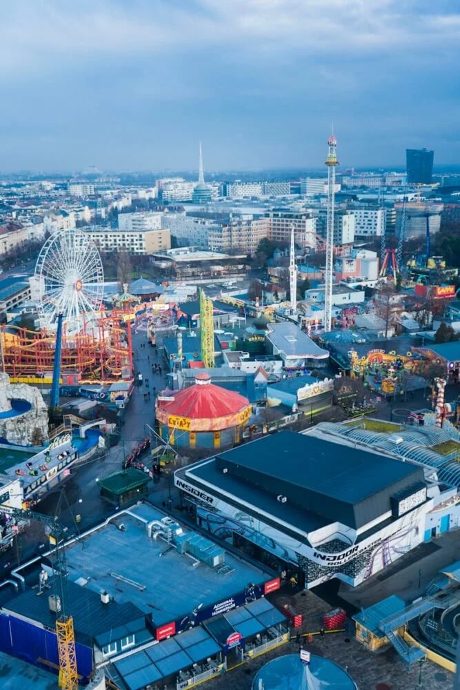 an aerial view of an amusement park with a ferris wheel