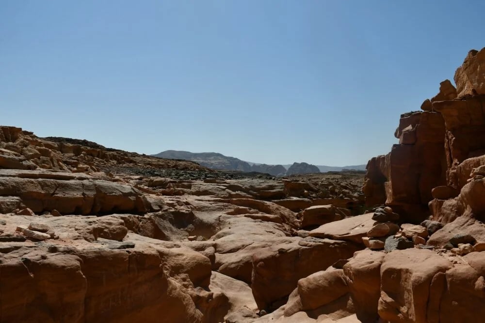 A large rock formation in the middle of a desert