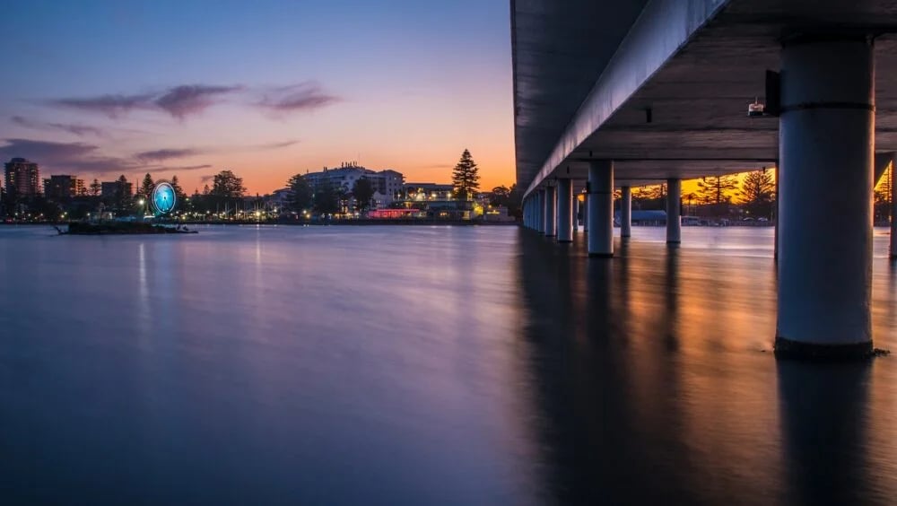 brown wooden dock on body of water during night time