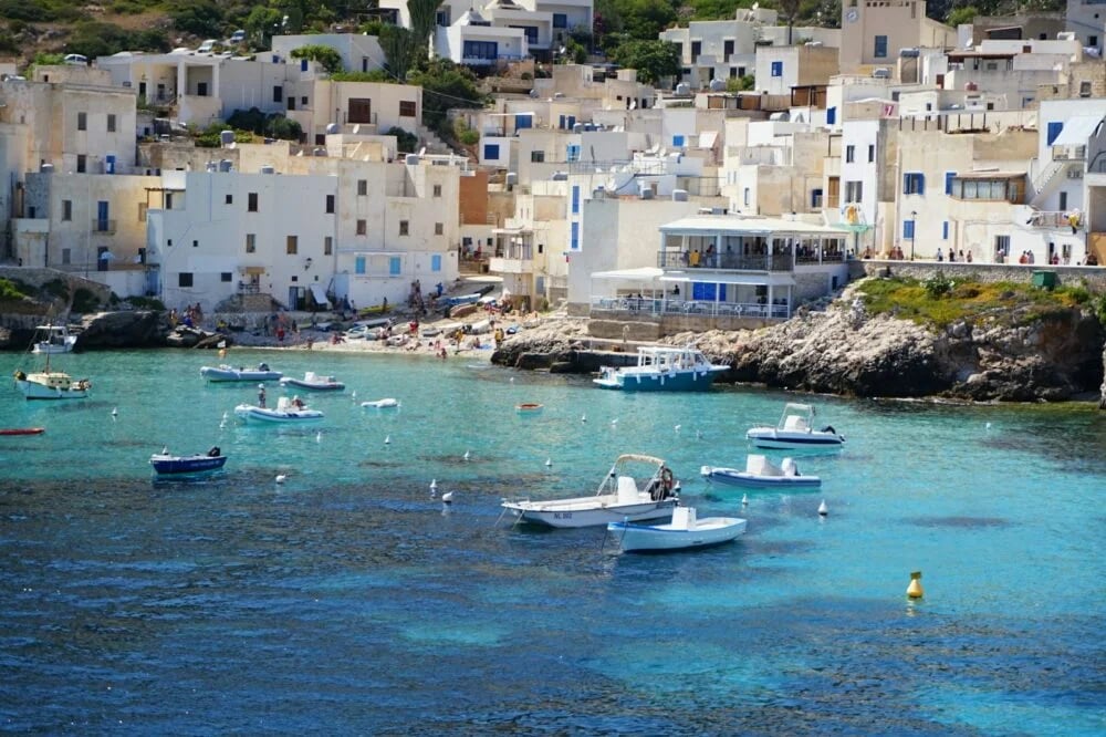 white and blue boat on sea during daytime