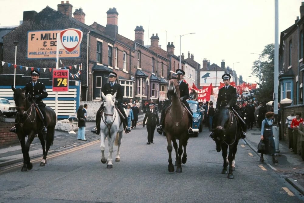 people riding horses on road during daytime