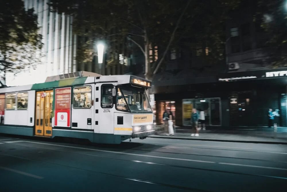 white and green tram on road during night time