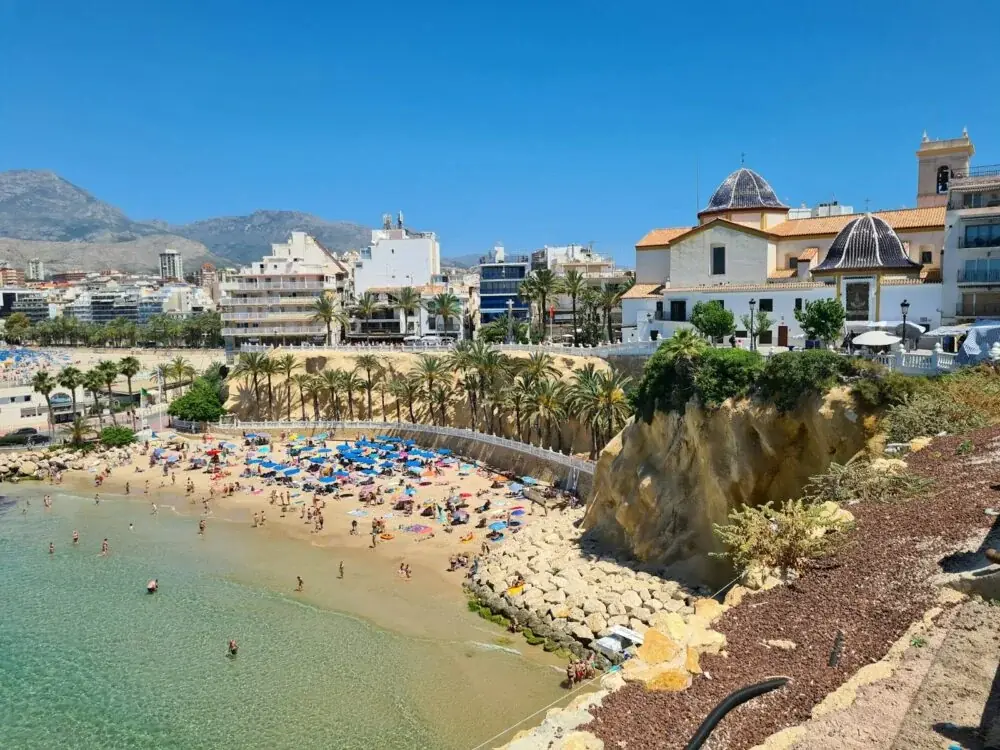 a beach with people and buildings