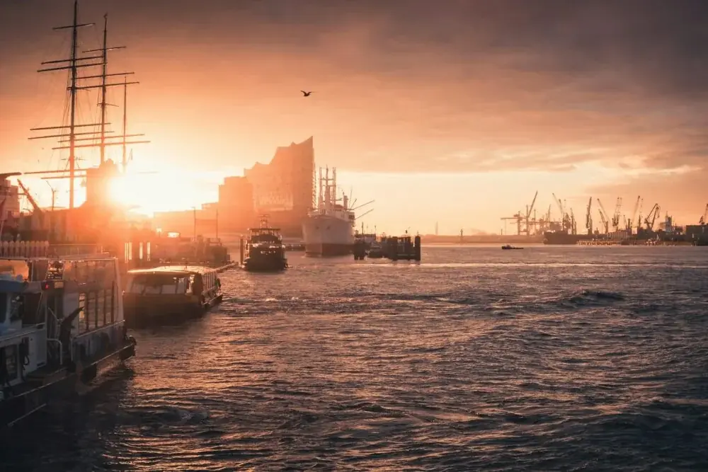 silhouette of boat on sea during sunset