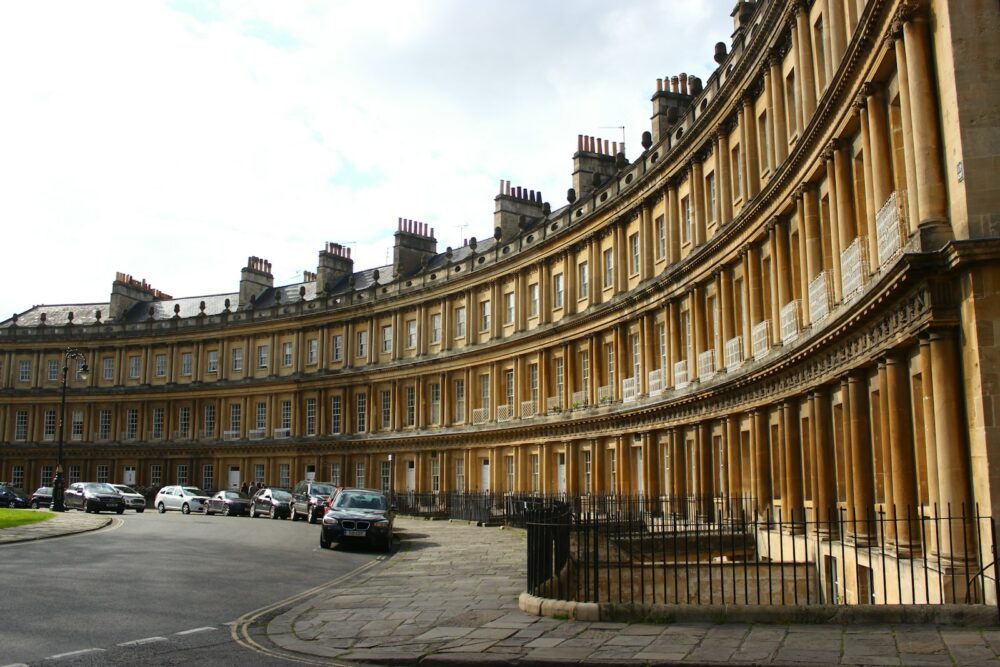 a curved building with cars parked in front of it