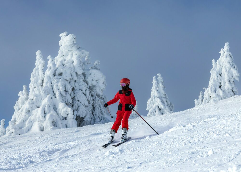 a person riding skis down a snow covered slope