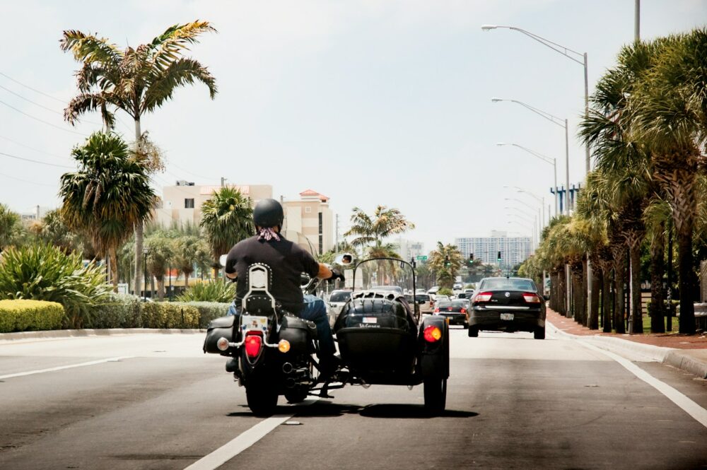 man in black jacket riding on black motorcycle during daytime