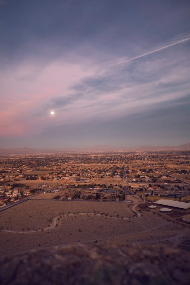 aerial photography of brown fields with houses under sun during daytime